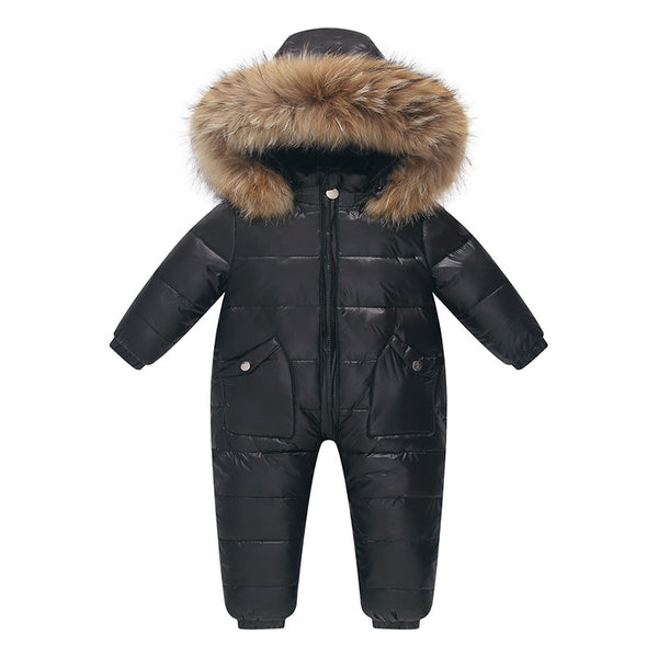 The Baby Wears White Eiderdown Over A Onesie And Down Jacket